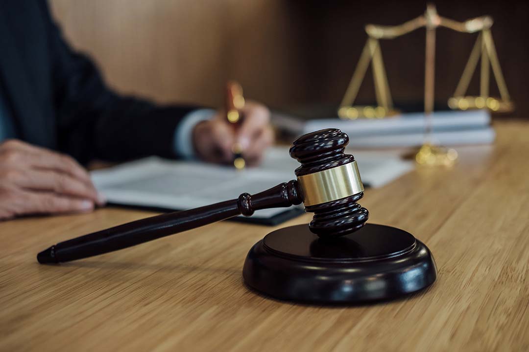 Illustration of a courtroom representing criminal defense services for DUI, assault, and more.